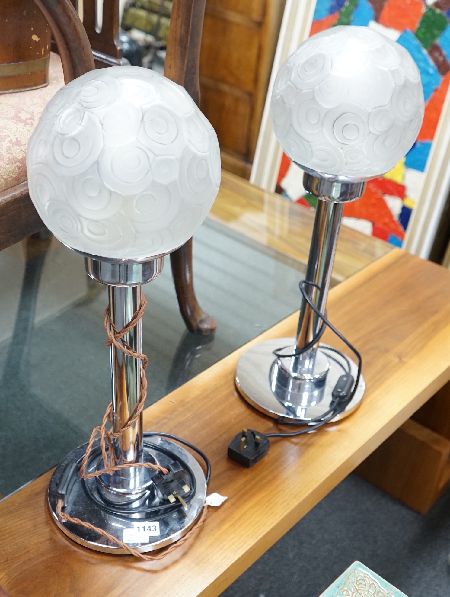 A pair of Art Deco style chrome and frosted glass lamps